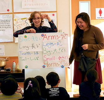 Two K students teaching English at a Japanese elementary school