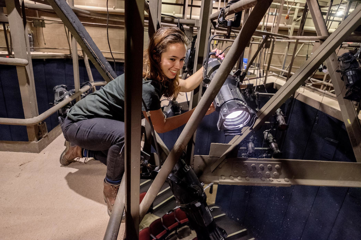 Student working industrial lighting