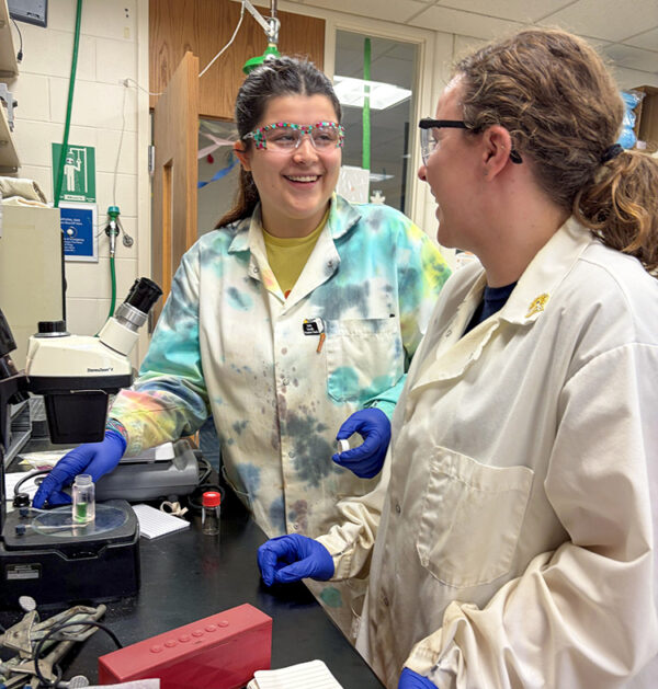 Meena Moritz and Caroline Johnson in the lab laughing. 