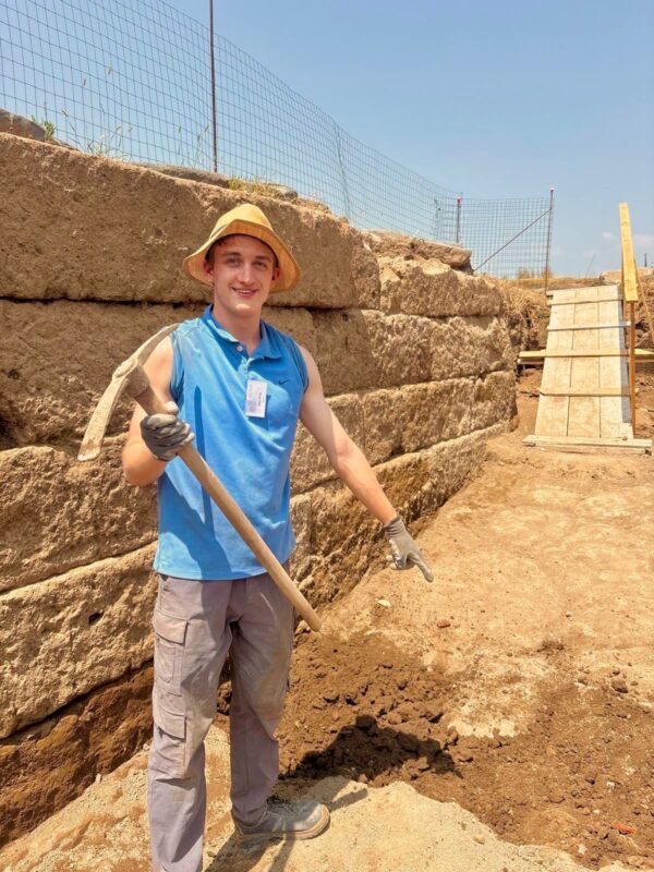 Sam King pointing to a find on the ground at Gabii dig site. 
