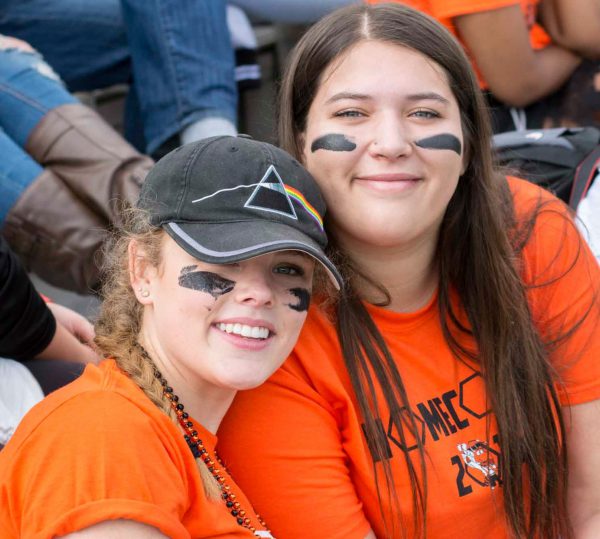 Two football fans dressed for National College Colors Day