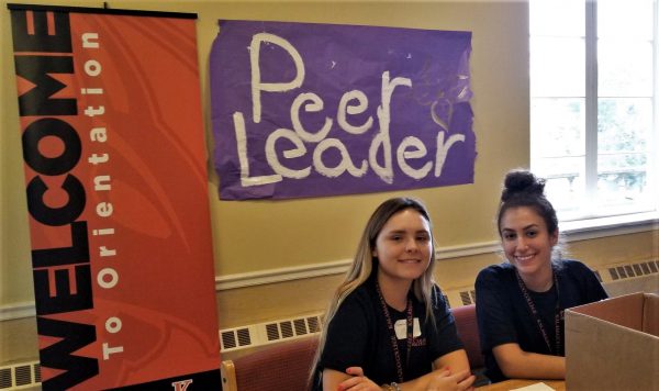 Two peer leaders assist students on move-in day