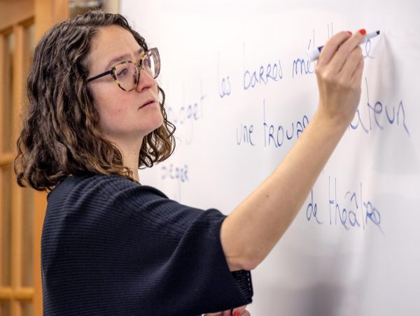 Aurélie Chatton, a faculty member at Kalamazoo College, writes on a dry-erase board during a class