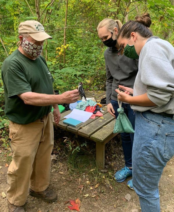 Grace Hancock works with two others at the birding station at Sarett Nature Center