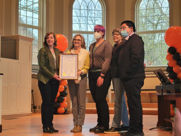 State Julie Rogers presents a certificate to CCE staff at Founders Day