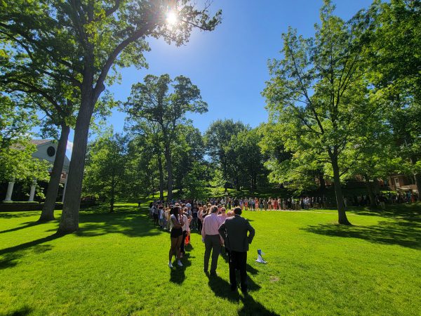 Students, faculty and staff practice the procession for Commencement on the Quad