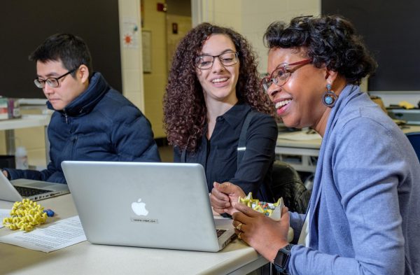 Science society will honor Regina Stevens-Truss who is smiling while teaching two students