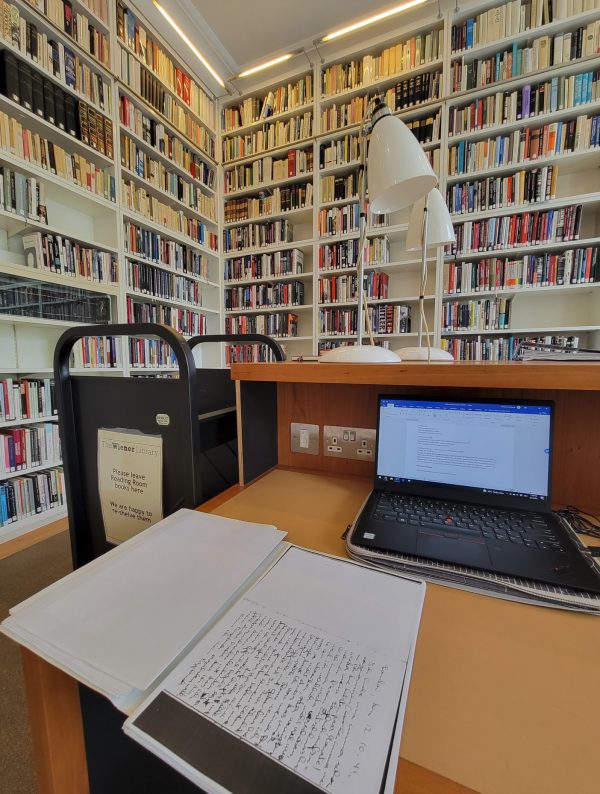 A Holocaust diary sits on a desk in front of a laptop comuter