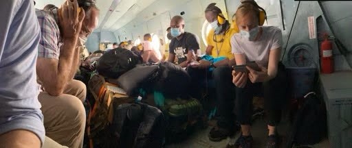 Sarah Fuhrman reading on a helicopter during a social justice mission