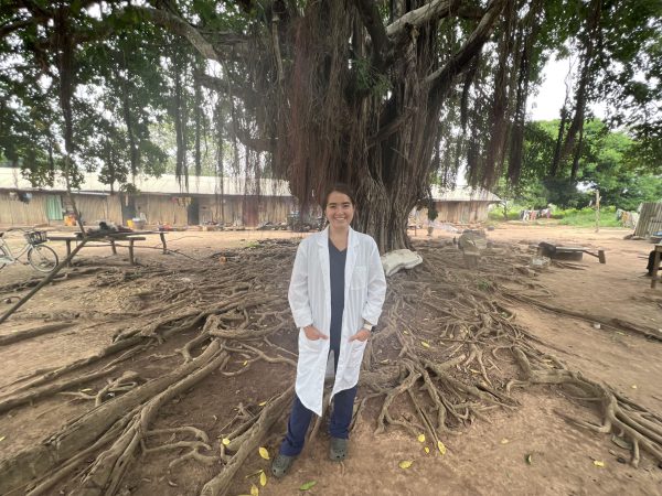 Rachel Kramer in front of a tree with large roots