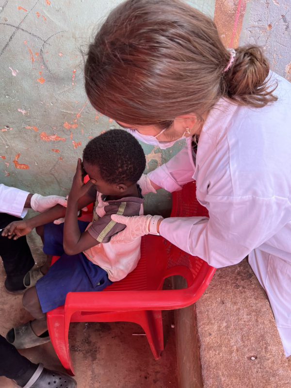 Rachel Kramer comforting a child providing a blood sample