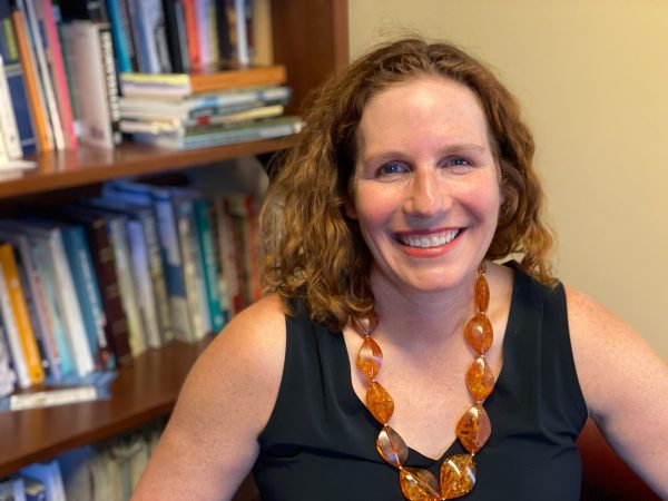 Professor of English Amelia Katanski in her office with books in the background