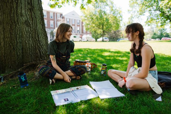 Two students talking on the Quad while studying for top 10 stories of 2023