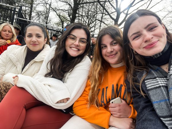 Four female students watching a baseball game