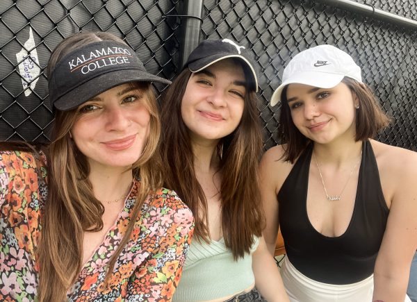 Three students attending a tennis match