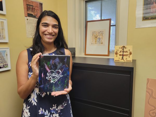 Sohini Pillai standing in her office with some Star Wars memorabilia