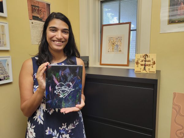 Sohini Pillai standing in her office with some Star Wars merchandise