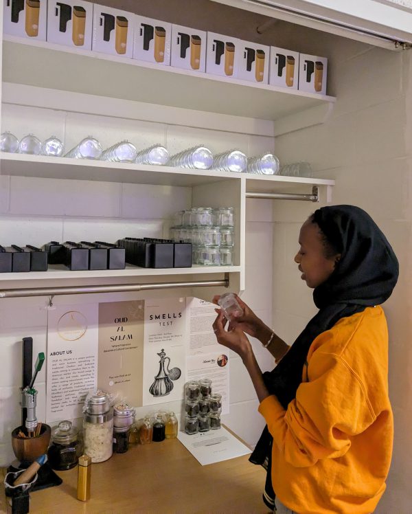 Darsalam Amir examining the supplies that go into her scents