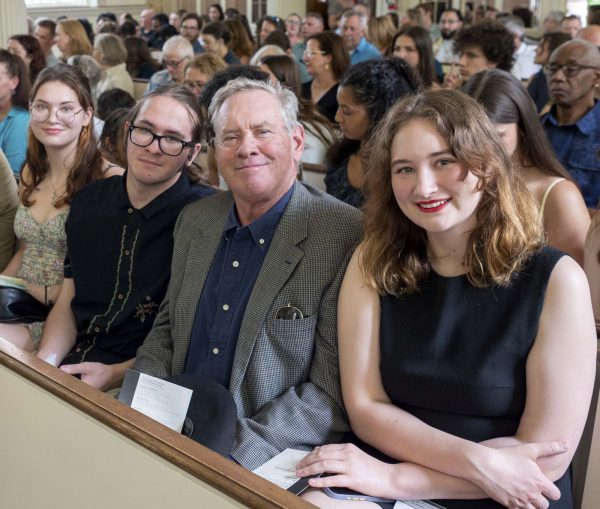 A student sits with three members of her family at the senior awards