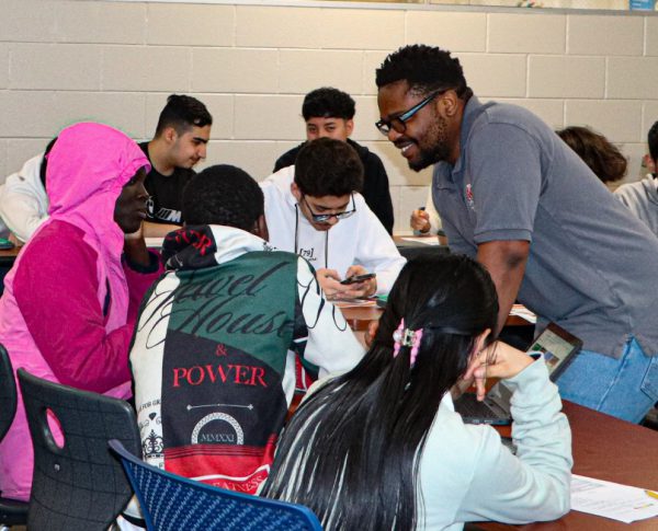 College student and filmmaker visiting students in a classroom