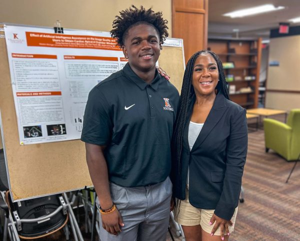 Two people attending the summer research symposium