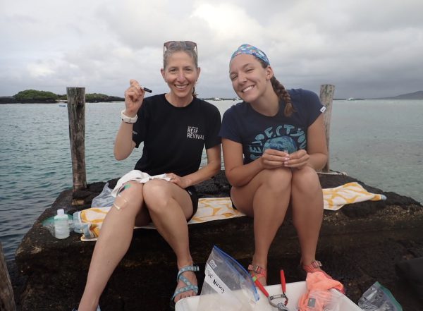 A student and professor performing marine research in the Galapagos Islands