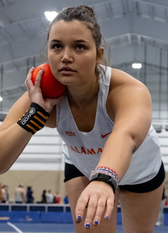 Zara Strauss prepares to throw the shot put and set a new personal mark during a women's track and field meet
