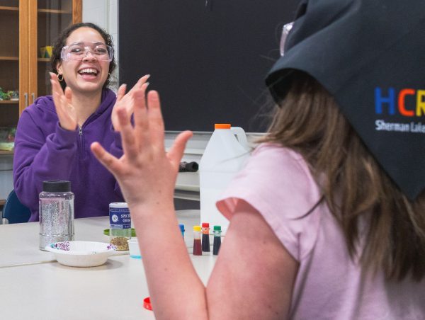 College student and child performing experiment