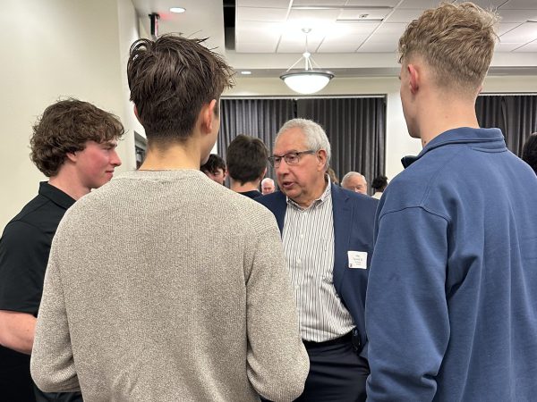 Students and an alumnus talk during Beyond the Game