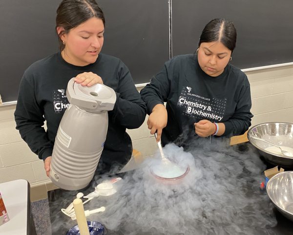 Two students perform experiments at Family Science Night in 2025