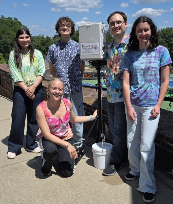Student researchers from Andrew Jensen's summer lab pose with an air-quality monitor