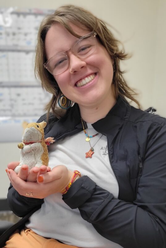 Swim for Success coach Maya Arau '27 with a plush squirrel toy