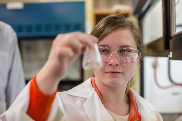 student holding a beaker