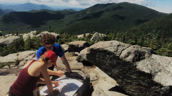 two students looking at a map in the Adirondack mountains 