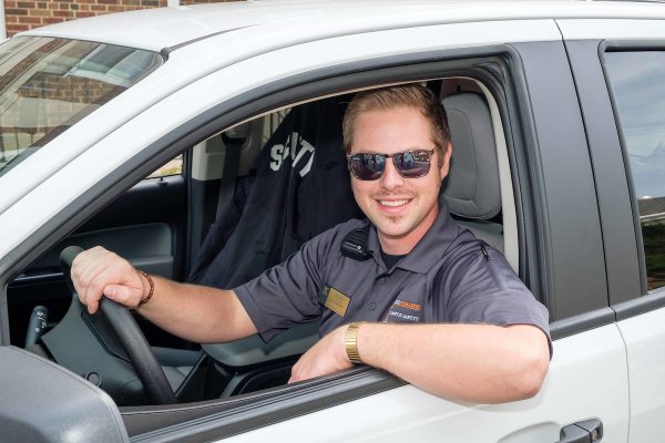 campus safety employee in his car