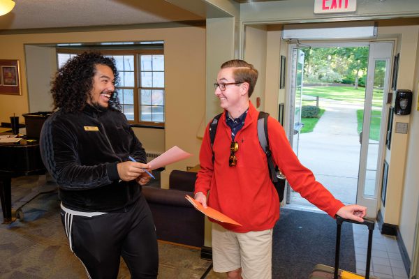 An RA speaking with a resident on move in day