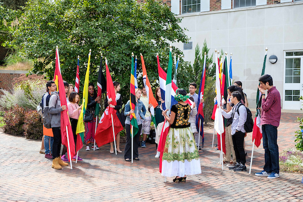 international students holding their respective flags