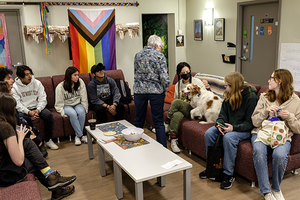 the Cavern gathering space filled with students and a therapy dog