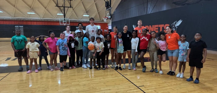 Bball-Woodward Fieldtrip 2 Student-athletes posing for a group photo with kids from a local school.