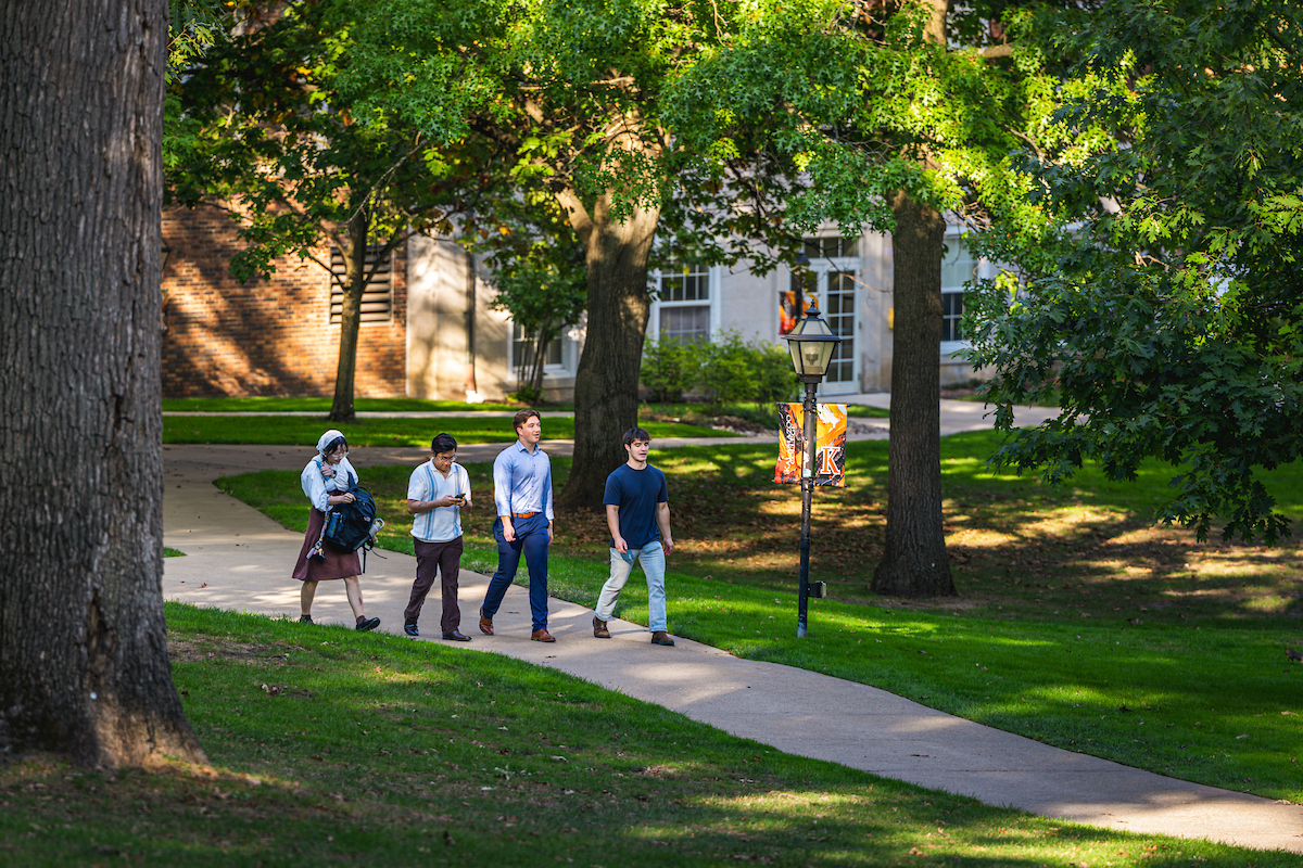 Four students walking on the quad. 