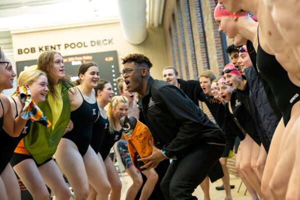 A group of swim and dive athletes cheering