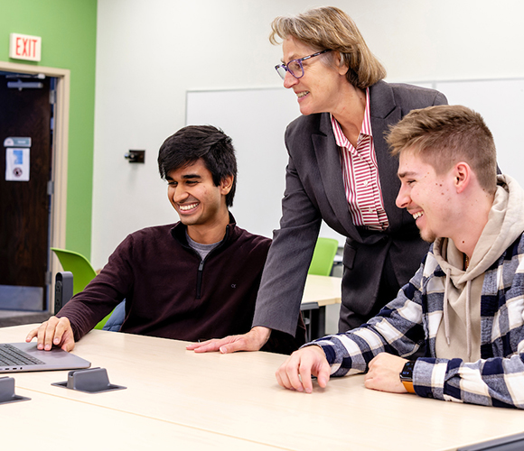 professor working with two students