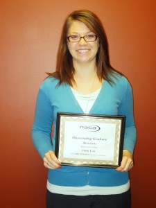 Emily Lott holds a framed NACA award
