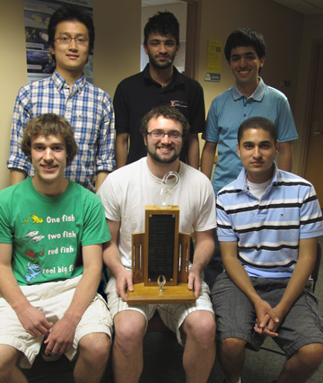 Six math students pose with a trophy