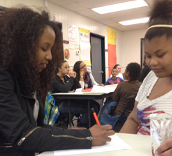 Raven Fisher helps a student with schoolwork