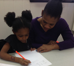 Roxann Lawrence helps a student with schoolwork