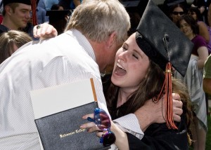 Female graduate hugging a well-wisher