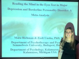Senior psychology major Mara Richman in front of a projection screen