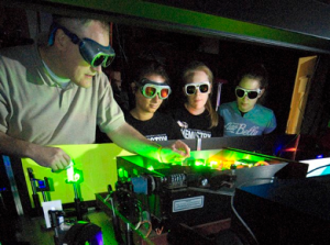 Professor Jeff Bartz with three students at K's laser lab