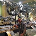 Joel Hutson ''02 with Ceratosaurus Carnotaurus at the Dinosaur Discovery Museum of Kenosha, Wisc.